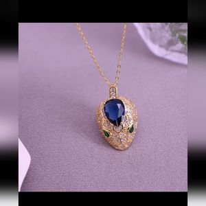 Snake blue stone and gold pendant